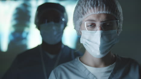 Portrait-of-Healthcare-Workers-in-Protective-Uniform-in-Dark-Lab